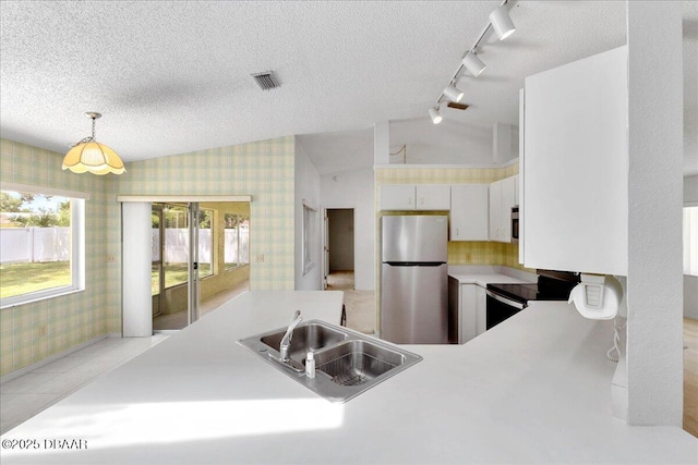 744 Hawks Ridge Rd, Port Orange, FL 32127 - kitchen featuring freestanding refrigerator, wallpapered walls, electric range, track lighting, and light countertops