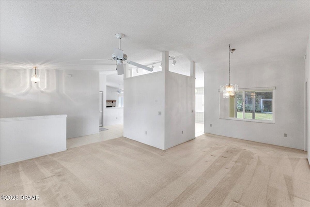 744 Hawks Ridge Rd, Port Orange, FL 32127 - spare room with carpet floors, a ceiling fan, a textured ceiling, and a chandelier