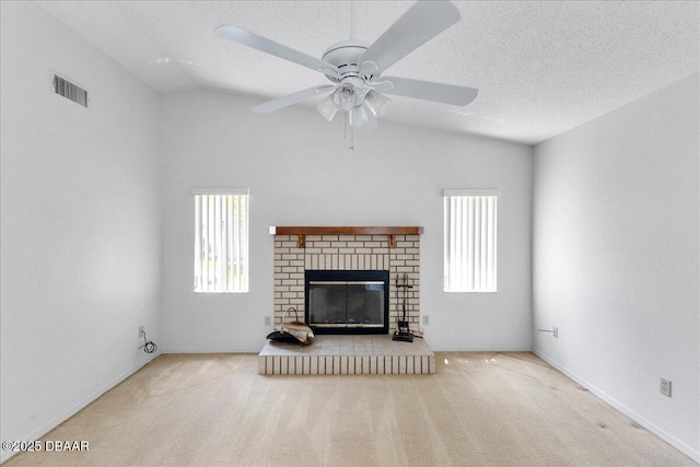 744 Hawks Ridge Rd, Port Orange, FL 32127 - unfurnished living room featuring carpet flooring, a ceiling fan, a fireplace, and a textured ceiling