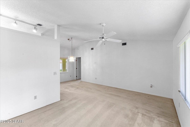 744 Hawks Ridge Rd, Port Orange, FL 32127 - spare room with a textured ceiling, ceiling fan, light carpet, and lofted ceiling