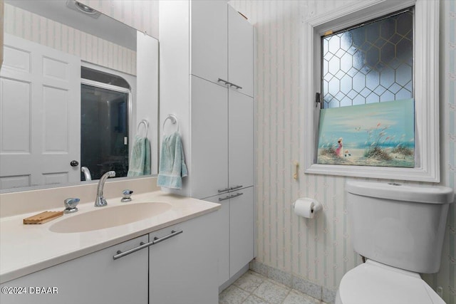 2934 Oceans Trce, Daytona Beach Shores, FL 32118 - bathroom with wallpapered walls, baseboards, vanity, and toilet