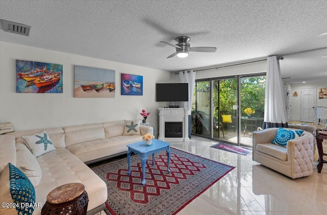 living room featuring a textured ceiling and ceiling fan