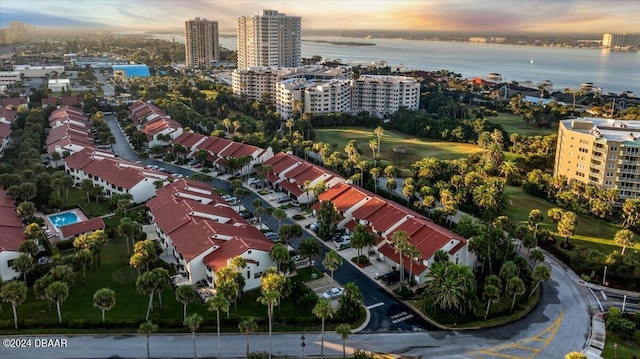 aerial view at dusk featuring a water view