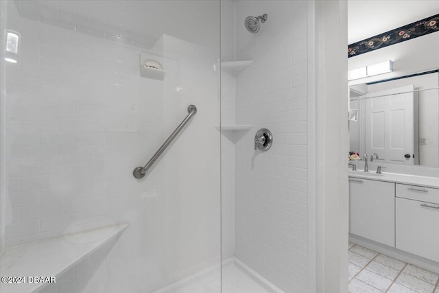 bathroom with vanity and a tile shower