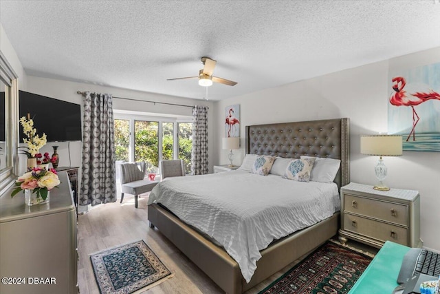 bedroom featuring a textured ceiling, light hardwood / wood-style flooring, and ceiling fan