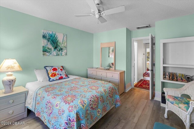 2934 Oceans Trce, Daytona Beach Shores, FL 32118 - bedroom featuring wood finished floors, a textured ceiling, and ceiling fan