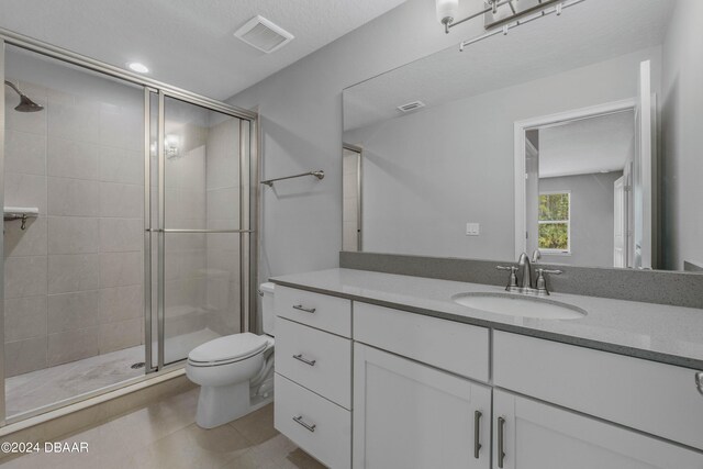 bathroom with toilet, an enclosed shower, and vanity