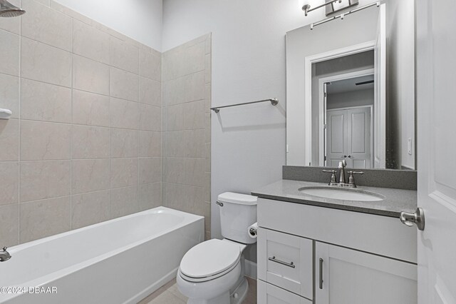 full bathroom with vanity, toilet, and tiled shower / bath