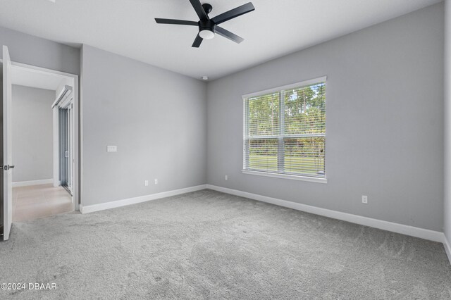 carpeted empty room with ceiling fan