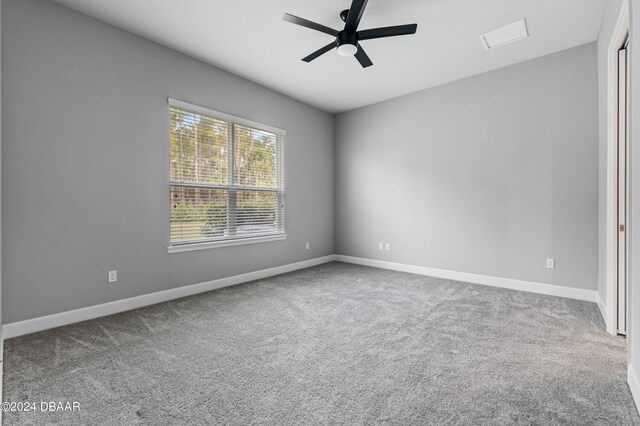 carpeted spare room with ceiling fan