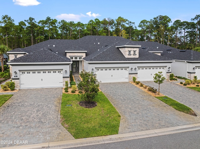 view of front of property featuring a garage and a front yard