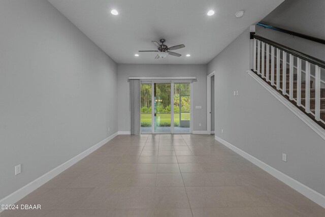 spare room with light tile patterned flooring and ceiling fan