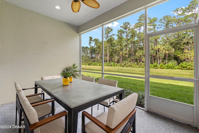 sunroom / solarium featuring ceiling fan