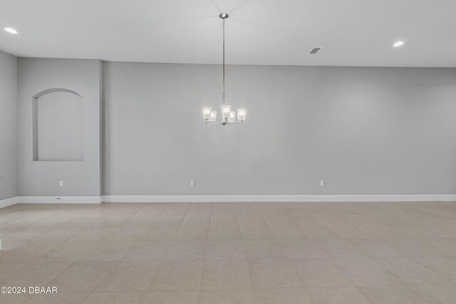 empty room featuring an inviting chandelier