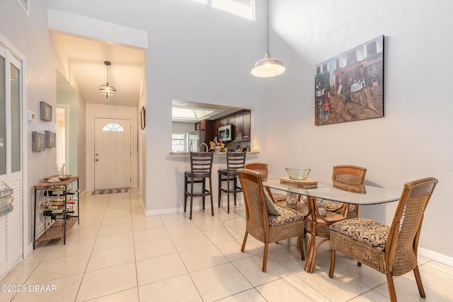 1237 Charter Oaks Cir, Holly Hill, FL 32117 - dining area featuring a high ceiling and light tile patterned floors