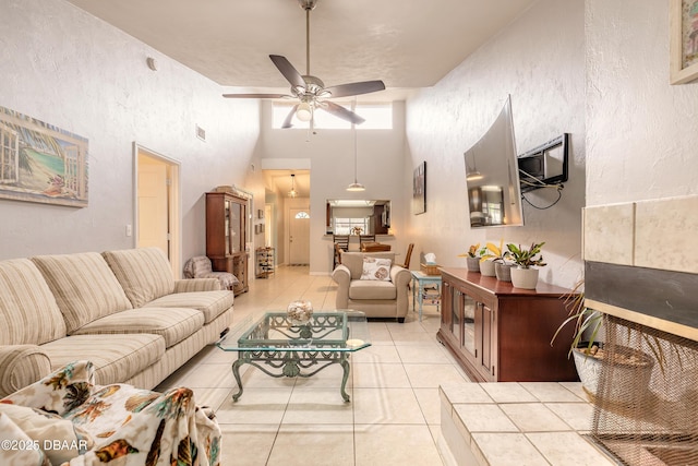 1237 Charter Oaks Cir, Holly Hill, FL 32117 - living area with a ceiling fan, light tile patterned flooring, a high ceiling, and a textured wall