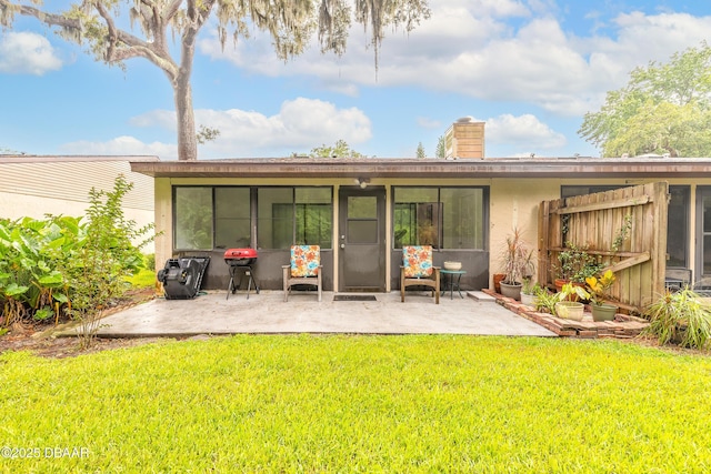 1237 Charter Oaks Cir, Holly Hill, FL 32117 - rear view of property with a patio, a chimney, a lawn, and stucco siding