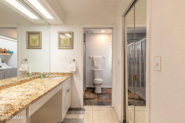 1237 Charter Oaks Cir, Holly Hill, FL 32117 - bathroom with washing machine and clothes dryer, vanity, and a shower with curtain