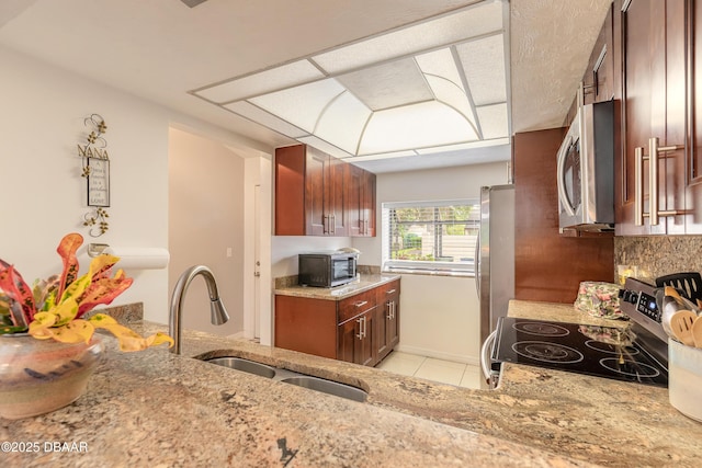 1237 Charter Oaks Cir, Holly Hill, FL 32117 - kitchen featuring stainless steel appliances, light stone countertops, light tile patterned floors, and decorative backsplash