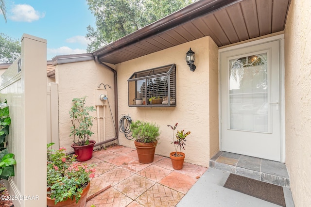 1237 Charter Oaks Cir, Holly Hill, FL 32117 - property entrance with stucco siding and a patio area