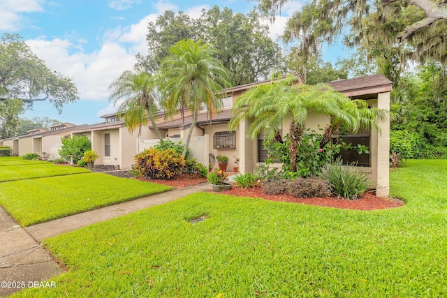 1237 Charter Oaks Cir, Holly Hill, FL 32117 - view of front of house with stucco siding and a front lawn