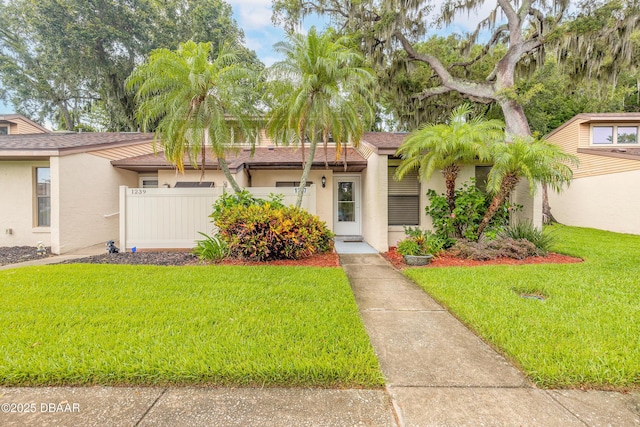 1237 Charter Oaks Cir, Holly Hill, FL 32117 - mid-century modern home with stucco siding and roof with shingles