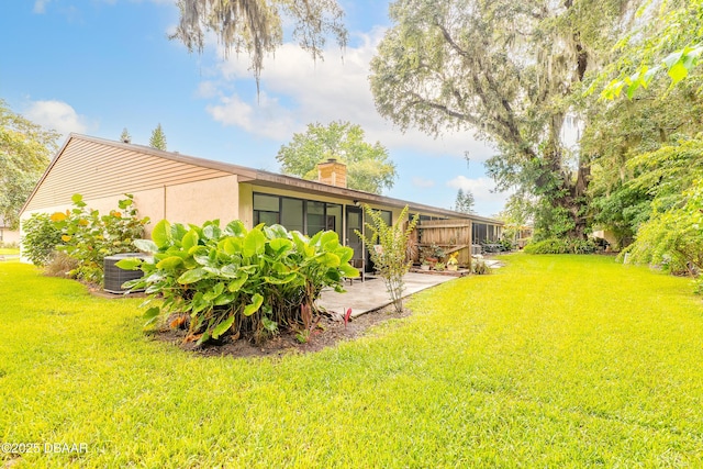 1237 Charter Oaks Cir, Holly Hill, FL 32117 - view of green lawn with a patio and a sunroom