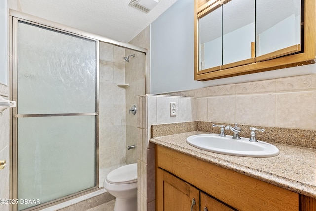 3726 S Atlantic Ave, New Smyrna Beach, FL 32169 - bathroom featuring vanity, a stall shower, tile walls, and tile patterned flooring