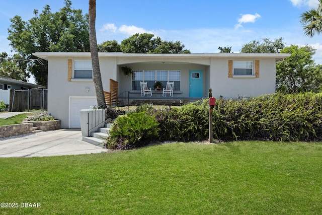 326 Flushing Ave, Daytona Beach, FL 32118 - single story home featuring a garage, stucco siding, driveway, a front lawn, and covered porch