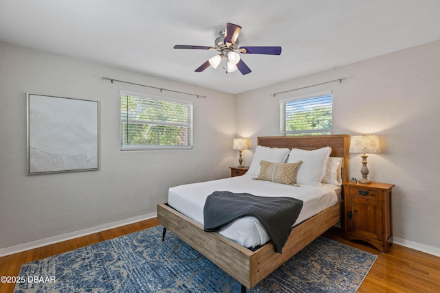 326 Flushing Ave, Daytona Beach, FL 32118 - bedroom featuring multiple windows, baseboards, wood finished floors, and ceiling fan