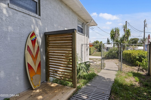 326 Flushing Ave, Daytona Beach, FL 32118 - view of side of property with a gate and stucco siding