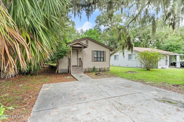 317 Reva St, Daytona Beach, FL 32114 - view of front facade featuring a front yard