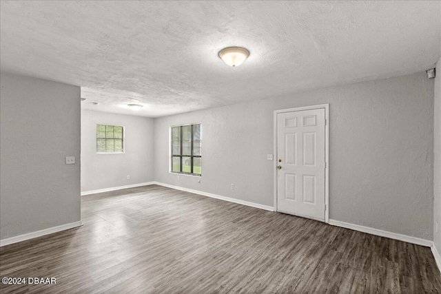 317 Reva St, Daytona Beach, FL 32114 - spare room with dark wood-style flooring, a textured ceiling, baseboards, and a textured wall