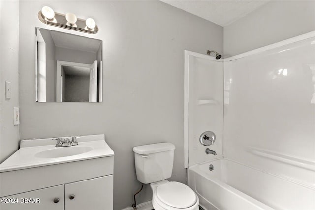 full bathroom with vanity, washtub / shower combination, toilet, and a textured ceiling