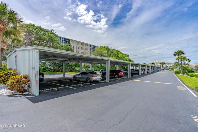 view of parking / parking lot featuring a carport