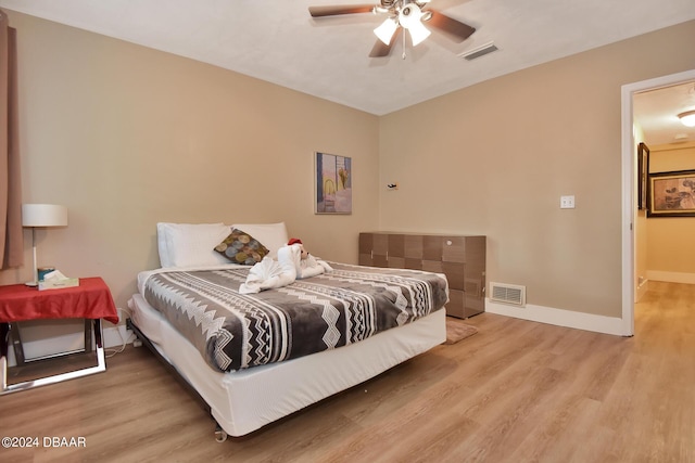 bedroom with ceiling fan and hardwood / wood-style floors