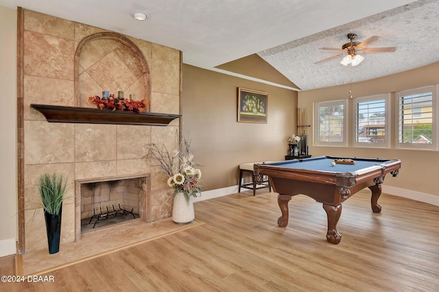 game room with hardwood / wood-style floors, a fireplace, billiards, lofted ceiling, and ceiling fan