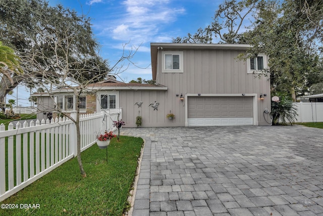 view of front of house with a garage and a front lawn