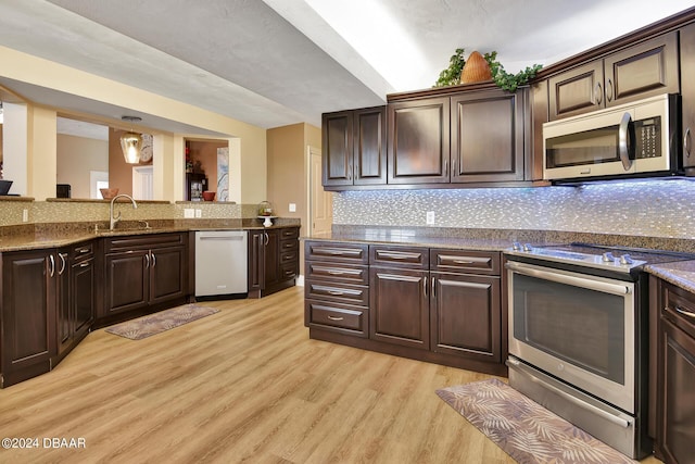 kitchen featuring dark brown cabinetry and appliances with stainless steel finishes