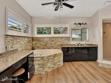 bathroom featuring hardwood / wood-style flooring, vanity, plenty of natural light, and ceiling fan