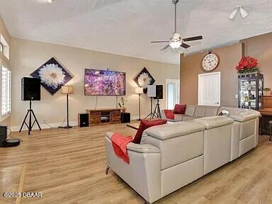 living room featuring ceiling fan and light wood-type flooring