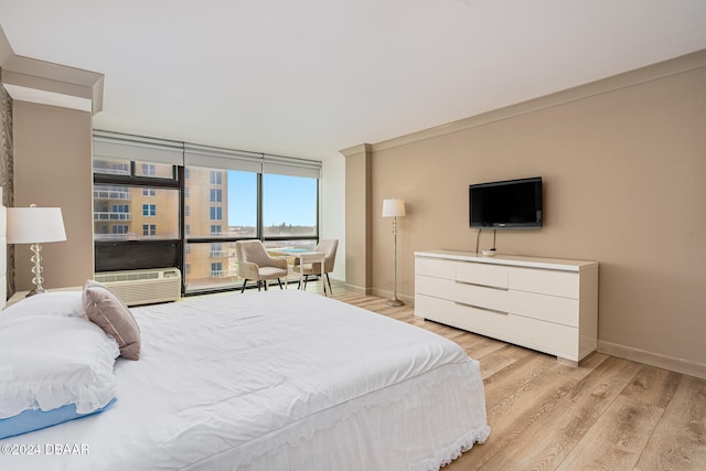 bedroom featuring light hardwood / wood-style floors and cooling unit