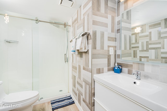 bathroom with toilet, vanity, an enclosed shower, and tile walls