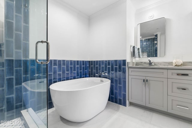 bathroom with tile walls, shower with separate bathtub, crown molding, and vanity