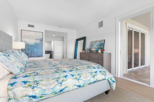 bedroom featuring hardwood / wood-style floors and ornamental molding