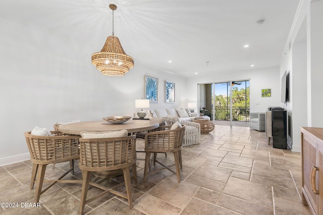 dining space featuring crown molding and an inviting chandelier