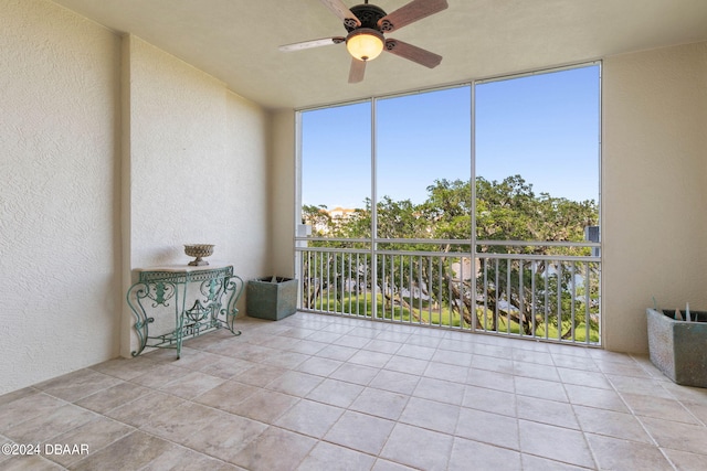 unfurnished sunroom with ceiling fan