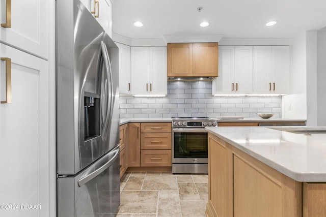 kitchen featuring tasteful backsplash, white cabinetry, appliances with stainless steel finishes, and ventilation hood