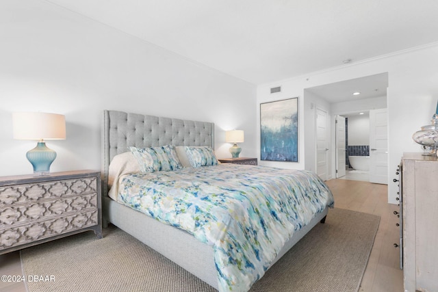 146 Palm Coast Resort Blvd Unit 409, Palm Coast, FL 32137 - bedroom featuring wood finished floors, ensuite bathroom, and recessed lighting