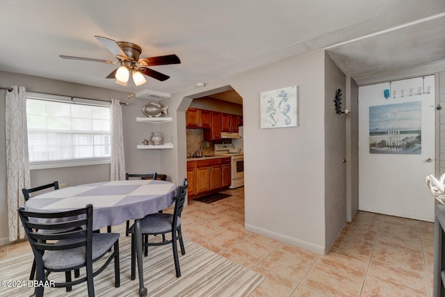 dining room featuring sink, ceiling fan, and light tile patterned flooring